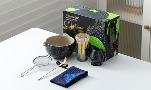 Sleek black-and-green packaging pairs with textured wares for a chic, contemporary matcha experience.
